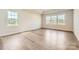 Bright bedroom with tray ceilings, three large windows and modern hardwood flooring at 1557 Croydon St, Indian Land, SC 29707