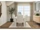 Inviting dining room features a wooden table, comfortable chairs, large window with natural light and decor at 1557 Croydon St, Indian Land, SC 29707