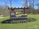 Landscaped community sign with stone base and wood pergola located at entrance to community at 1557 Croydon St, Indian Land, SC 29707