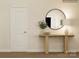 Stylish entryway with a round mirror, wooden console table, decor, and a white door, creating a welcoming ambiance at 1557 Croydon St, Indian Land, SC 29707