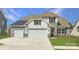 Inviting home featuring a three-car garage, stone accents, and manicured lawn at 1557 Croydon St, Indian Land, SC 29707