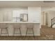 Bright, modern kitchen island with pendant lighting, stainless steel appliances, and hardwood floors at 1557 Croydon St, Indian Land, SC 29707