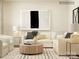 Bright living room featuring a sectional sofa, modern art, and a round wood coffee table at 1557 Croydon St, Indian Land, SC 29707