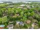 Aerial view showcasing homes near a lake, surrounded by mature trees and manicured lawns, offering a serene residential setting at 16421 Breckshire Dr, Huntersville, NC 28078