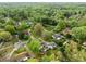 Aerial view of a neighborhood showcasing mature trees, well-maintained lawns, and diverse home styles on a winding street at 16421 Breckshire Dr, Huntersville, NC 28078