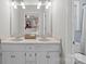 Bathroom featuring a double vanity with framed mirrors and neutral countertops at 16421 Breckshire Dr, Huntersville, NC 28078
