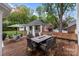 View of deck with outdoor table, chairs, and gazebo in landscaped backyard at 16421 Breckshire Dr, Huntersville, NC 28078