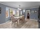 Dining room with large bay window and table adjacent to the kitchen at 16421 Breckshire Dr, Huntersville, NC 28078