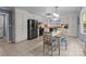 Bright dining room with white cabinets, stainless steel appliances, and tile floors at 16421 Breckshire Dr, Huntersville, NC 28078