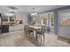 Bright dining room features a bay window, tile floor, and a table with seating for four at 16421 Breckshire Dr, Huntersville, NC 28078