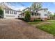 Charming two-story home with a brick foundation, white siding, covered front porch, and a separate two-car garage at 16421 Breckshire Dr, Huntersville, NC 28078