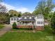 Charming two-story home with a brick foundation, white siding, covered front porch, and a separate two-car garage at 16421 Breckshire Dr, Huntersville, NC 28078