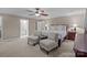 Spacious main bedroom featuring plush carpeting, a ceiling fan, and plenty of natural light at 16421 Breckshire Dr, Huntersville, NC 28078