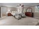 Spacious main bedroom featuring plush carpeting, a ceiling fan, and plenty of natural light at 16421 Breckshire Dr, Huntersville, NC 28078
