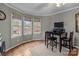Bright office space with large windows, hardwood floors, and built-in desk area at 16421 Breckshire Dr, Huntersville, NC 28078
