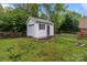 Exterior of a white storage shed with a black door and white garage door at 16421 Breckshire Dr, Huntersville, NC 28078