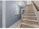 Carpeted staircase featuring natural light and neutral walls at 16421 Breckshire Dr, Huntersville, NC 28078