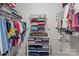 Organized walk-in closet with ample shelving and rods for efficient storage at 16421 Breckshire Dr, Huntersville, NC 28078