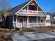 Charming two-story home with a welcoming porch and 'For Sale' sign, perfect for families and new homeowners at 1703 Polk St, Monroe, NC 28110