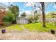 Charming backyard featuring a well-kept shed with a stone pathway and lush greenery at 1717 Thomas Ave, Charlotte, NC 28205