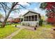 Spacious backyard showcasing a screened porch, lush lawn, and charming landscaping at 1717 Thomas Ave, Charlotte, NC 28205