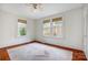 Spacious bedroom with original hardwood floors and windows providing natural light at 1717 Thomas Ave, Charlotte, NC 28205