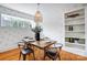 Dining room with hardwood floors, modern chandelier, and table set for four at 1717 Thomas Ave, Charlotte, NC 28205