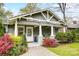 Inviting front porch with white pillars, rocking chairs, and colorful plants framing the entrance at 1717 Thomas Ave, Charlotte, NC 28205