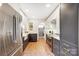 Galley kitchen featuring stainless steel appliances, terra cotta flooring and shaker cabinets at 1717 Thomas Ave, Charlotte, NC 28205
