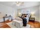 Bedroom with hardwood floors, ceiling fan, accent pillows, and neutral walls at 1717 Thomas Ave, Charlotte, NC 28205