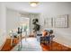 Office space with hardwood floors, natural light, and decorative chair and desk at 1717 Thomas Ave, Charlotte, NC 28205