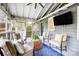 Inviting screened porch with comfortable seating, ceiling fan, and mounted TV at 1717 Thomas Ave, Charlotte, NC 28205