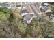 Aerial view of home with fenced backyard, screened porch, deck and mature trees at 18518 Lahaina Ln, Charlotte, NC 28278