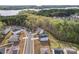 Neighborhood with homes, tree coverage and a lake in the distance at 18518 Lahaina Ln, Charlotte, NC 28278