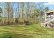 Spacious backyard featuring a well-maintained lawn, mature trees, and outdoor seating area at 18518 Lahaina Ln, Charlotte, NC 28278