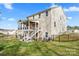 Spacious backyard featuring a deck with stairs leading to a screened-in porch at 18518 Lahaina Ln, Charlotte, NC 28278