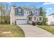 Charming two-story home featuring a welcoming front porch, two-car garage, and well-maintained landscaping at 18518 Lahaina Ln, Charlotte, NC 28278