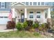 Inviting front porch featuring stone accents, white columns, and an American flag at 18518 Lahaina Ln, Charlotte, NC 28278