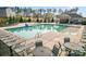 Community pool with lounge chairs and tables, perfect for relaxing and enjoying the summer at 18518 Lahaina Ln, Charlotte, NC 28278