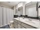 Bathroom with double sinks, framed mirrors, shower with a curtain, and toilet at 1986 Thoreau Way, York, SC 29745