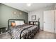 Comfortable bedroom with a green accent wall, cozy furniture and good natural light at 1986 Thoreau Way, York, SC 29745