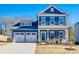 Charming two-story blue home with a well-manicured lawn and two-car garage at 1986 Thoreau Way, York, SC 29745