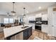 Modern kitchen with white cabinetry, stainless steel appliances, and a center island overlooking the living area at 1986 Thoreau Way, York, SC 29745