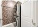 Laundry room featuring floral wallpaper, a stacked washer and dryer, and access to storage at 1986 Thoreau Way, York, SC 29745