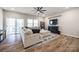 Comfortable living room with fireplace, TV, modern fan and sliding glass doors to an outdoor space at 1986 Thoreau Way, York, SC 29745