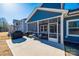 Exterior of a screened porch featuring patio seating, an outdoor grill, and backyard access at 1986 Thoreau Way, York, SC 29745