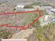 Aerial view of wooded property with approximate property lines overlaid in red at 2018 Fox Creek Trl, Lincolnton, NC 28092