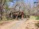 Charming rustic home with a covered front porch and driveway in a wooded setting at 2018 Fox Creek Trl, Lincolnton, NC 28092