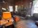 Cozy living room boasts a charming fireplace, wood paneling, and vintage decor at 2018 Fox Creek Trl, Lincolnton, NC 28092