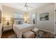 Comfortable bedroom with a queen bed, ceiling fan, and bright natural light at 2021 Nolen Park Ln, Charlotte, NC 28209